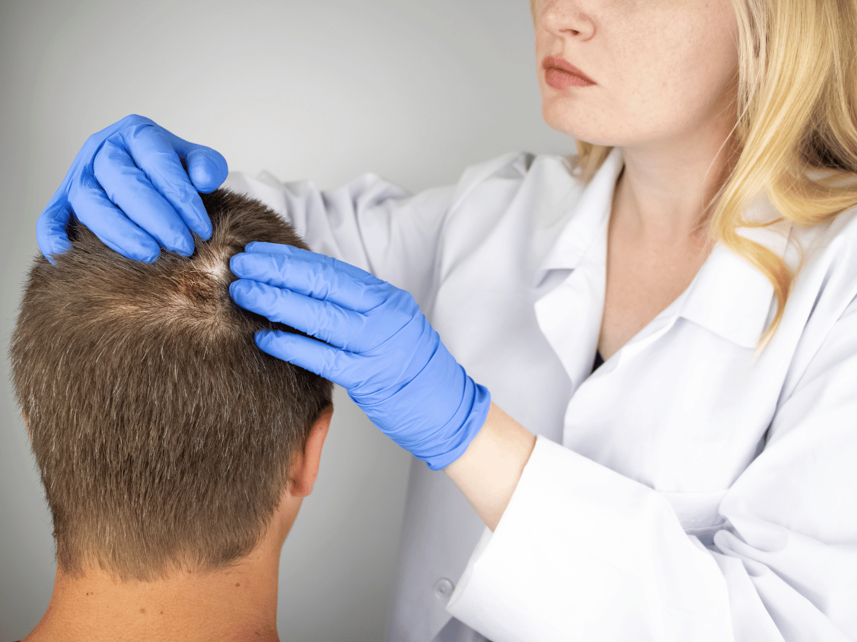 dermatologist looking at balding head