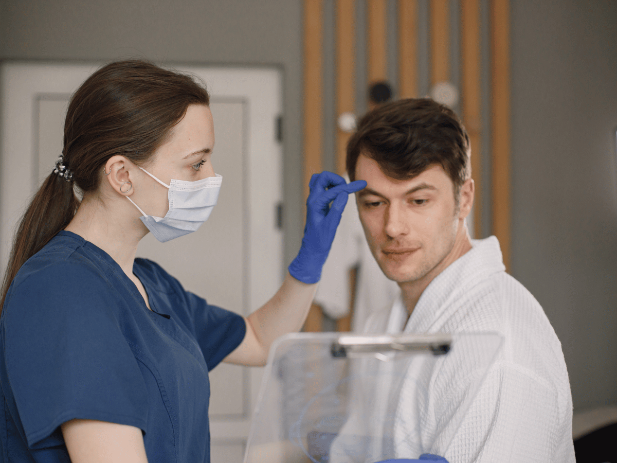 Patient in exam room being examined by doctor